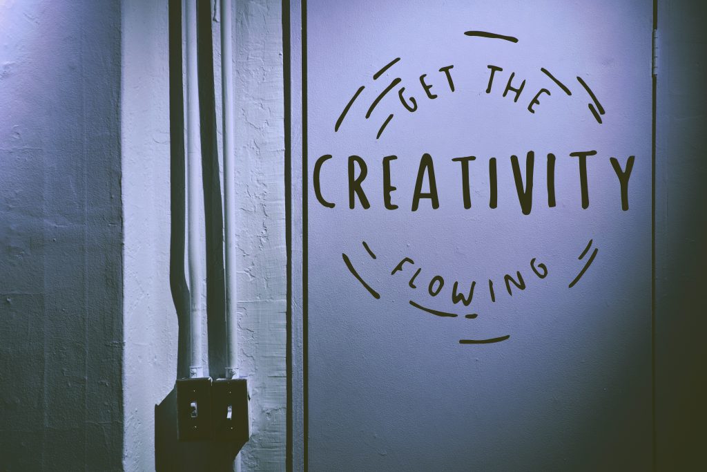 The words "Get the creativity flowing" painted on a door