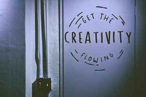 The words "Get the creativity flowing" painted on a door